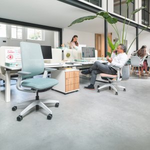 Version haute du se:flex Sedus avec repose-pieds devant une table debout