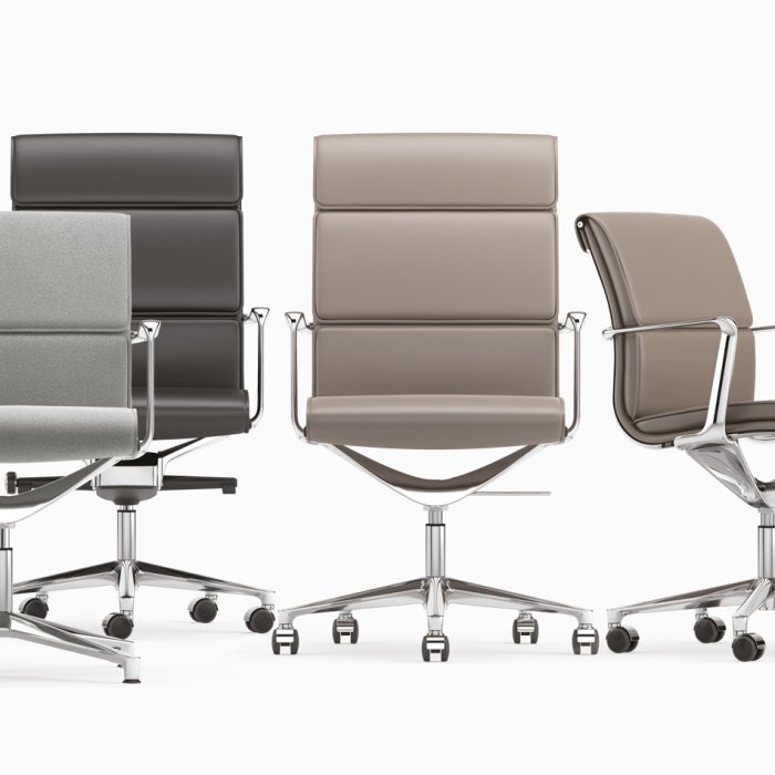 Fauteuil de direction en cuir cognac à haut dossier, bureau en noyer, fin de journée dans une direction générale parisienne